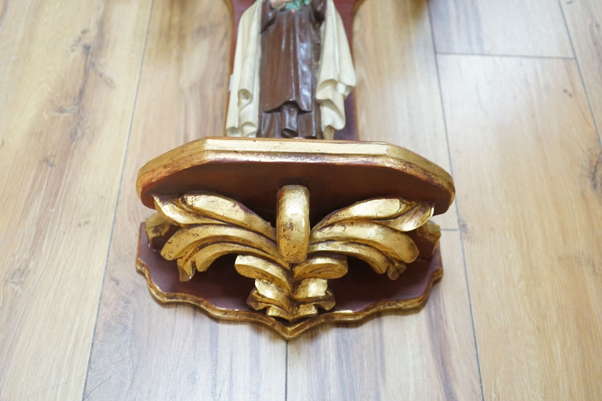 A carved gilt niche with a carved painted Madonna, 68cm